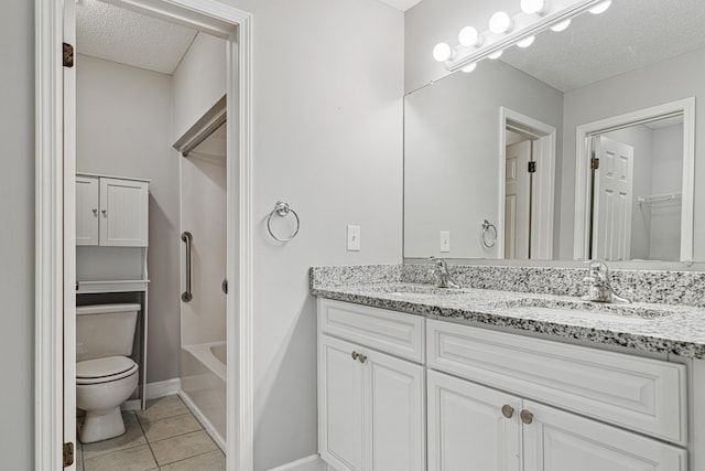 303 Southlake Ct Unit 303, Niceville, FL 32578 - bathroom featuring a textured ceiling, double vanity, toilet, a closet, and tile patterned floors
