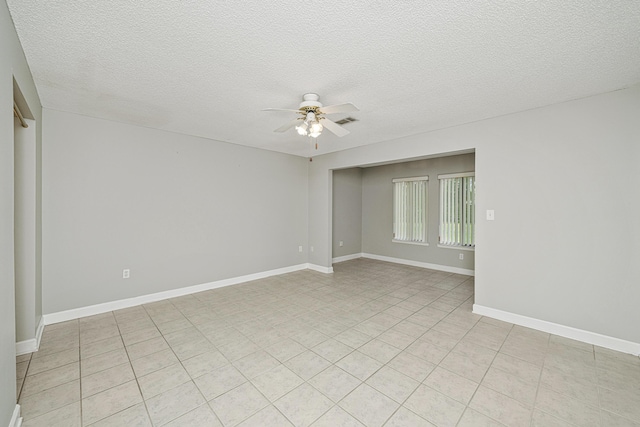 303 Southlake Ct Unit 303, Niceville, FL 32578 - empty room with a ceiling fan, light tile patterned floors, a textured ceiling, and baseboards