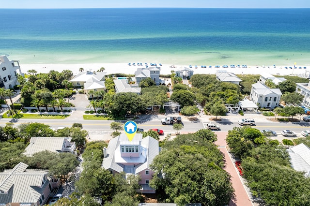 aerial view featuring a view of the beach, a water view, and a residential view