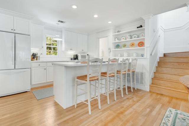 kitchen featuring open shelves, visible vents, white appliances, and white cabinets