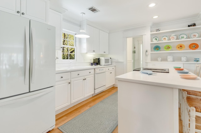 kitchen with visible vents, white cabinets, and white appliances