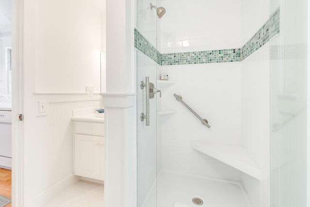 full bathroom featuring a shower stall and vanity