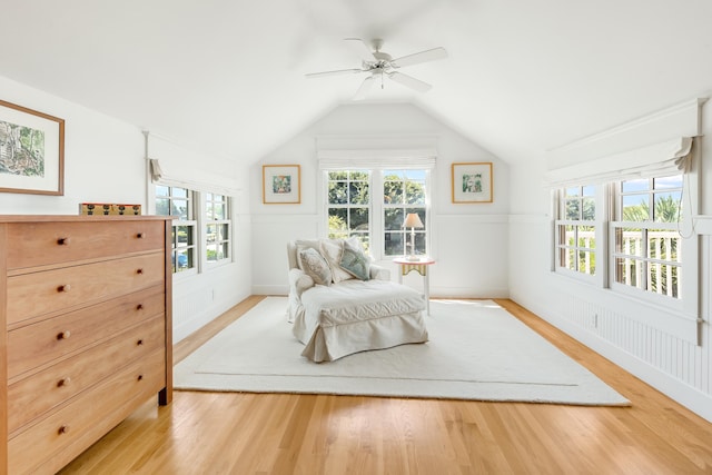 sitting room featuring lofted ceiling, a healthy amount of sunlight, and light wood-style flooring