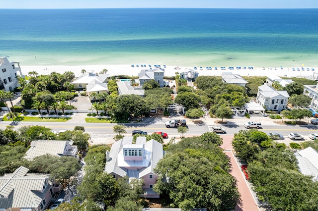 drone / aerial view featuring a residential view, a water view, and a beach view