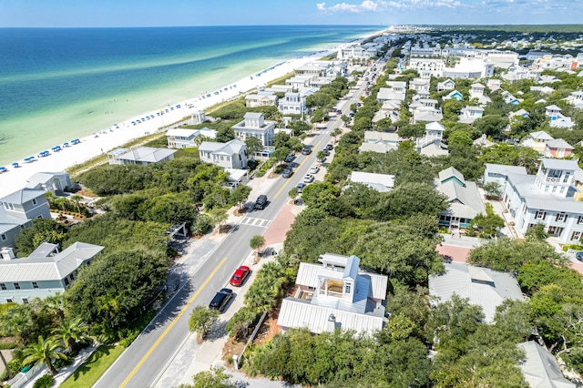 drone / aerial view featuring a view of the beach, a residential view, and a water view