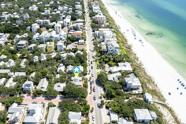 aerial view with a residential view, a beach view, and a water view