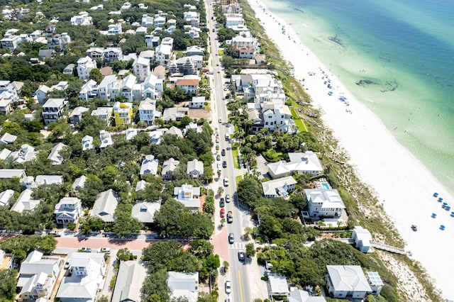 aerial view with a residential view, a beach view, and a water view