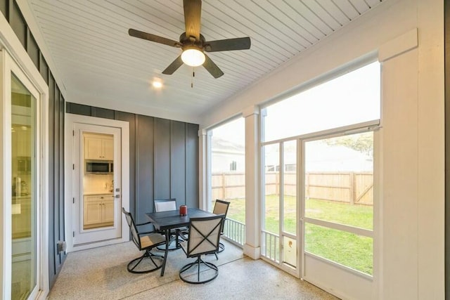 sunroom featuring ceiling fan