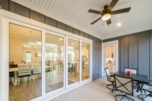 exterior space featuring a ceiling fan and wood ceiling