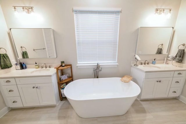 bathroom with two vanities, a soaking tub, and a sink