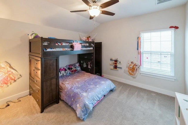 bedroom featuring light colored carpet, visible vents, baseboards, vaulted ceiling, and a ceiling fan