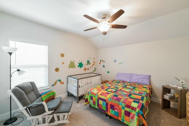 carpeted bedroom with vaulted ceiling, a ceiling fan, and baseboards