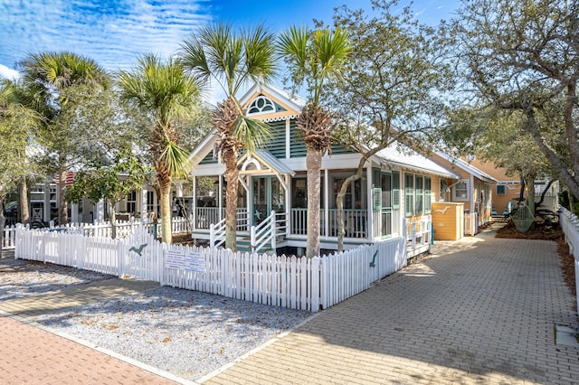 view of front facade with a fenced front yard and a gate