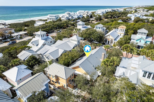 birds eye view of property featuring a beach view, a water view, and a residential view