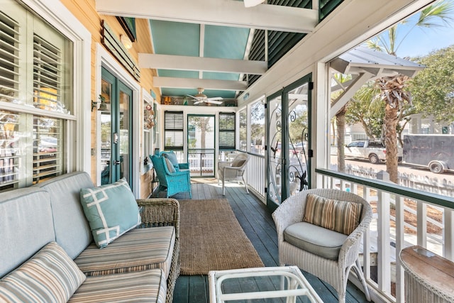 sunroom featuring ceiling fan