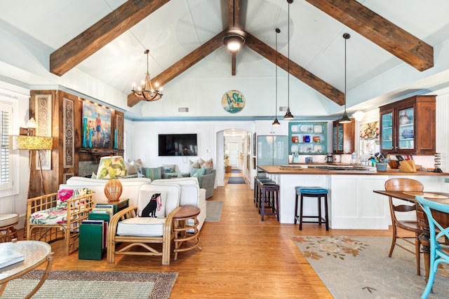 living area featuring arched walkways, visible vents, light wood-style flooring, high vaulted ceiling, and beamed ceiling