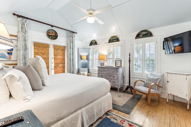 bedroom featuring a ceiling fan, lofted ceiling, and wood-type flooring