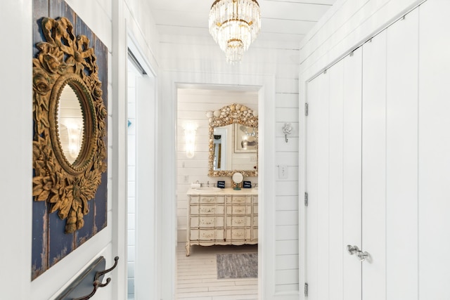 hallway with an inviting chandelier