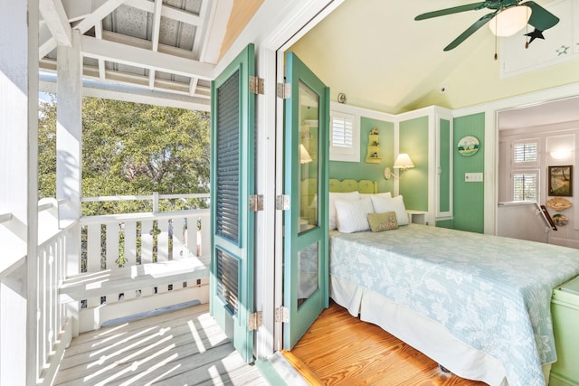 bedroom featuring vaulted ceiling, multiple windows, and a ceiling fan