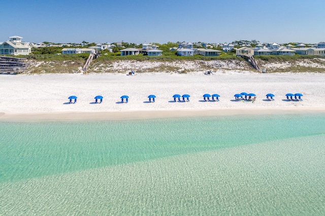 drone / aerial view with a water view and a beach view