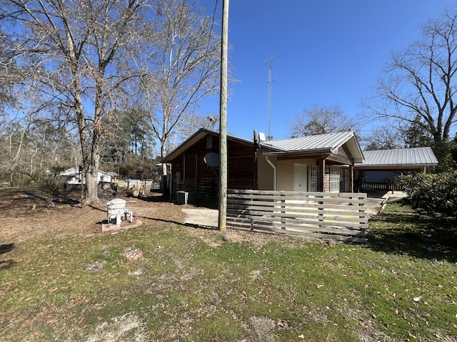 view of home's exterior featuring central air condition unit and metal roof