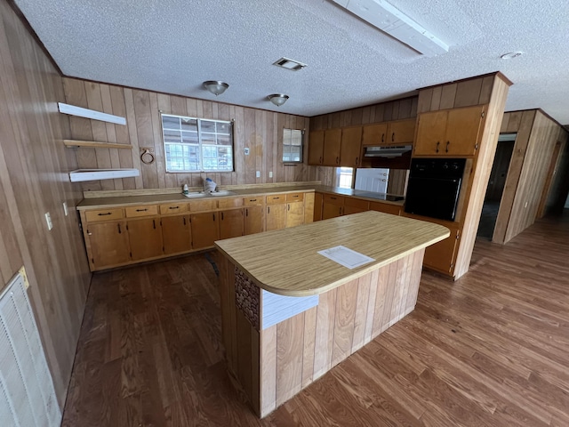 kitchen with open shelves, black appliances, visible vents, and light countertops