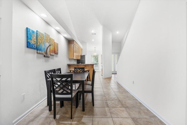 dining area with light tile patterned floors, recessed lighting, and baseboards