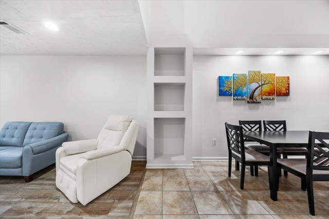 tiled dining room featuring visible vents, baseboards, and recessed lighting