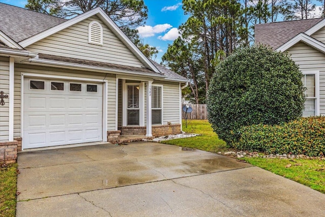 view of front of property featuring driveway, roof with shingles, an attached garage, fence, and brick siding