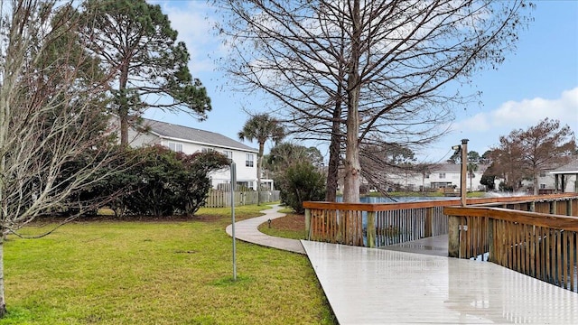 view of yard featuring a residential view, fence, and a wooden deck