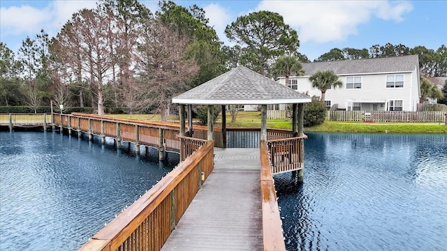 view of dock with a gazebo and a water view