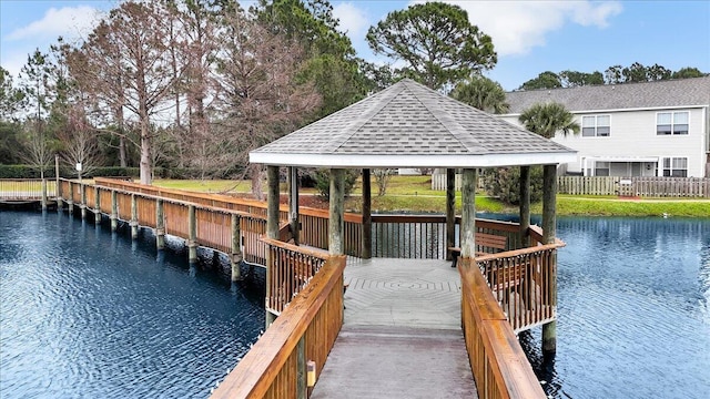 view of dock featuring a gazebo and a water view