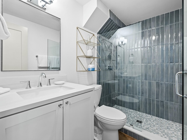 full bath featuring toilet, a shower stall, and vanity