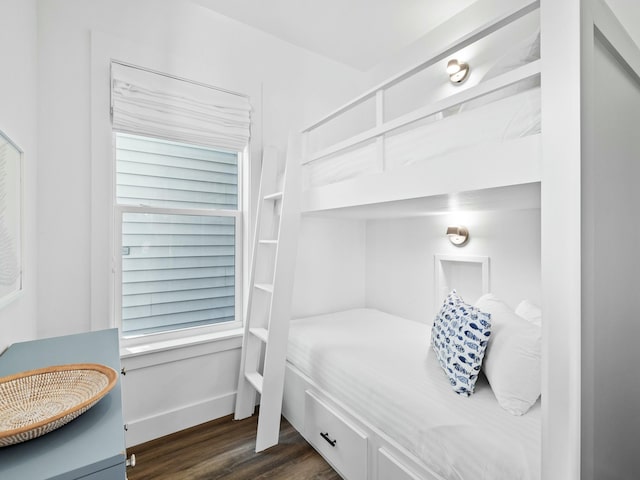 bedroom featuring dark wood finished floors and baseboards