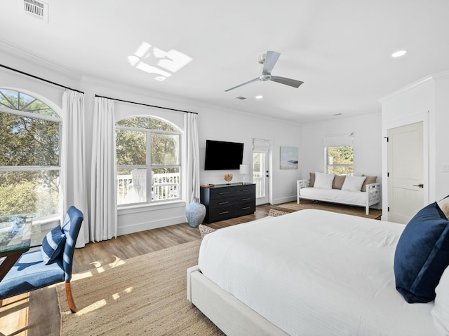 bedroom with ornamental molding, wood finished floors, visible vents, and recessed lighting