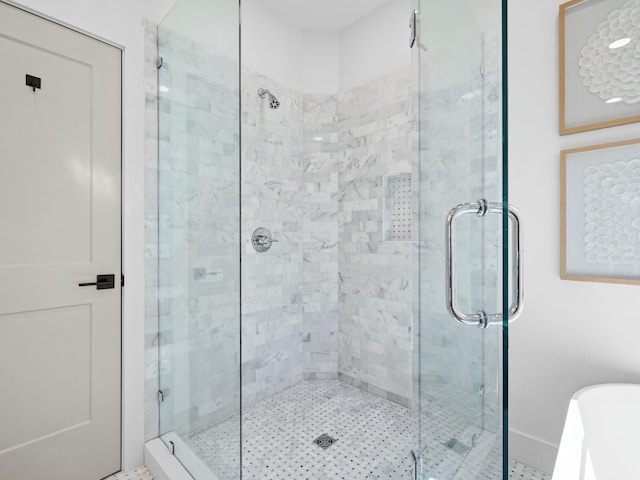 full bathroom with a freestanding tub and a shower stall