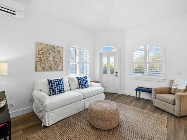 living area featuring a wall mounted AC, wood finished floors, and baseboards