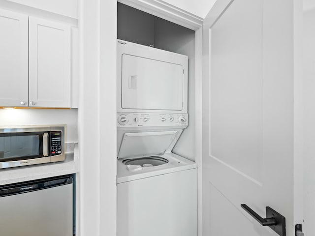 laundry room featuring laundry area and stacked washer / drying machine