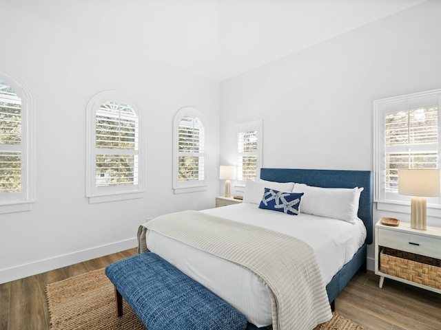 bedroom with baseboards and wood finished floors