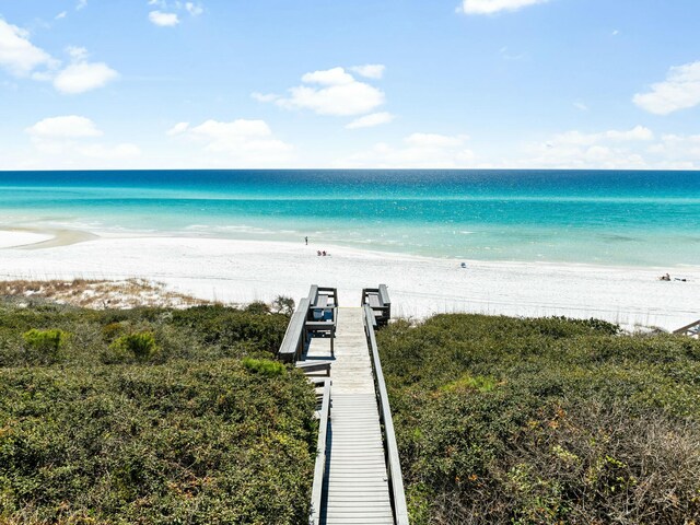 view of water feature with a dock and a beach view