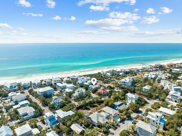 drone / aerial view featuring a beach view and a water view