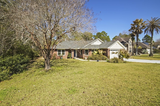 single story home with concrete driveway, a front lawn, an attached garage, and brick siding