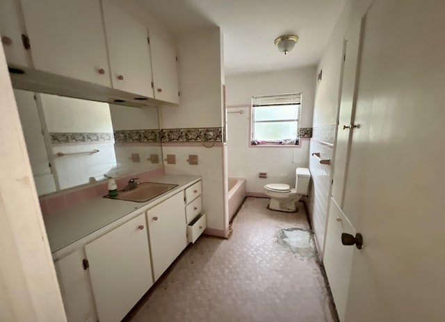 bathroom with toilet, vanity, a bathtub, and tile walls