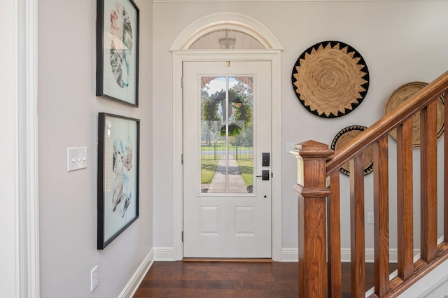 entryway with stairs, baseboards, and dark wood-style flooring