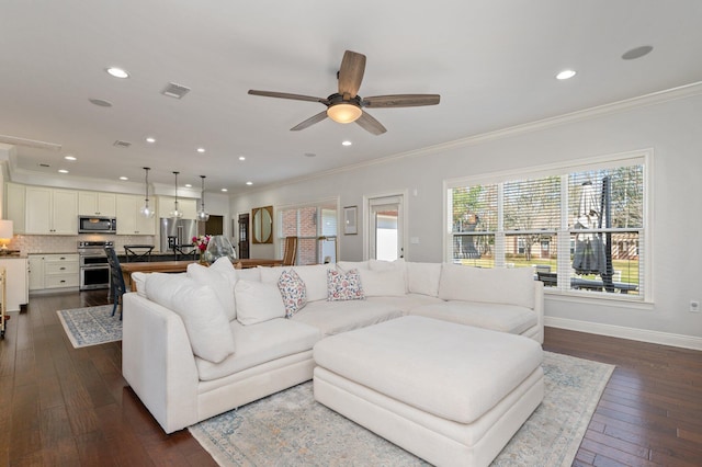 living room featuring baseboards, visible vents, dark wood finished floors, and crown molding