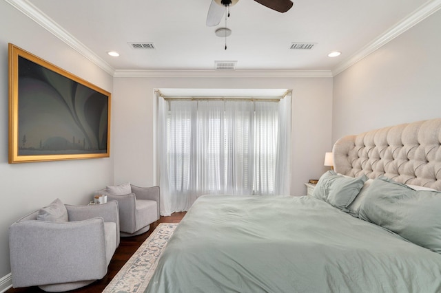 bedroom featuring dark wood-style floors, visible vents, and crown molding