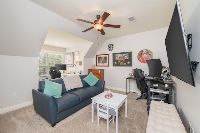 office space featuring lofted ceiling, visible vents, light carpet, and baseboards