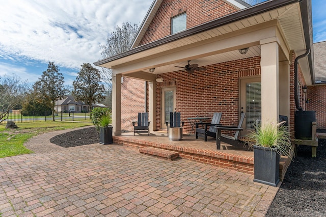 view of patio with ceiling fan and fence