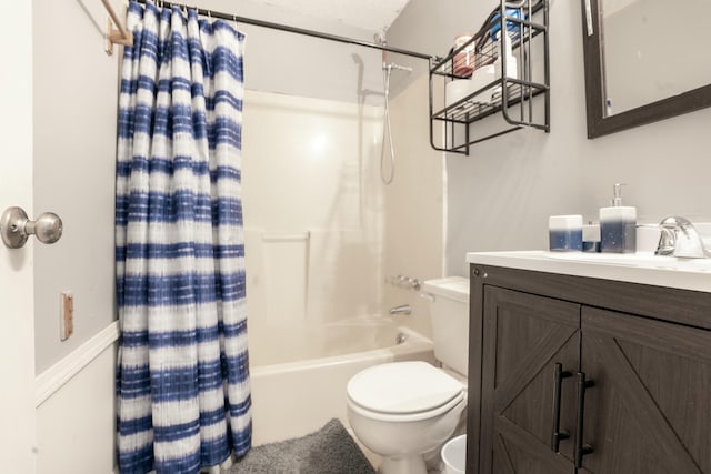 bathroom featuring toilet, shower / tub combo with curtain, and vanity