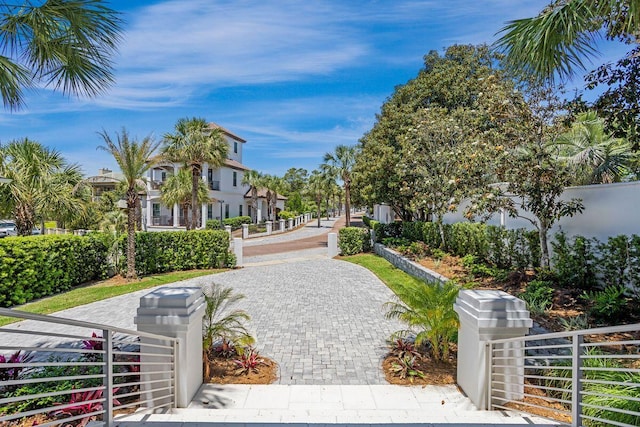 view of property's community with a fenced front yard and a gate